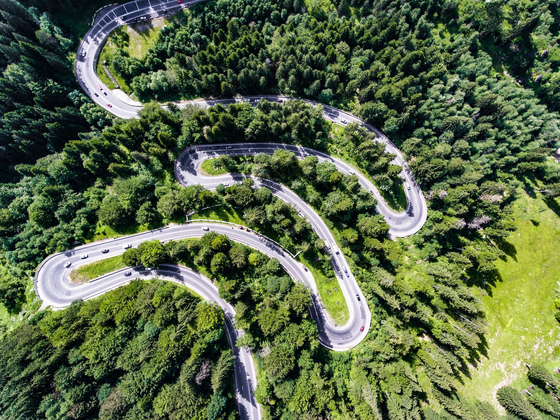Winding road through the mountains in the spring. An analogy for this blog post for a confusing path for donors trying to make a donation.