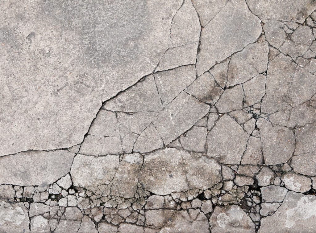 Cracked concrete texture closeup background